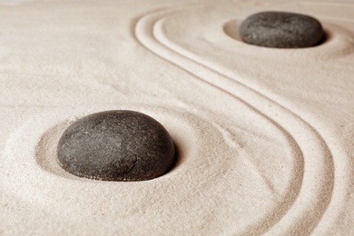 Zen garden stones on sand with pattern. Meditation and harmony