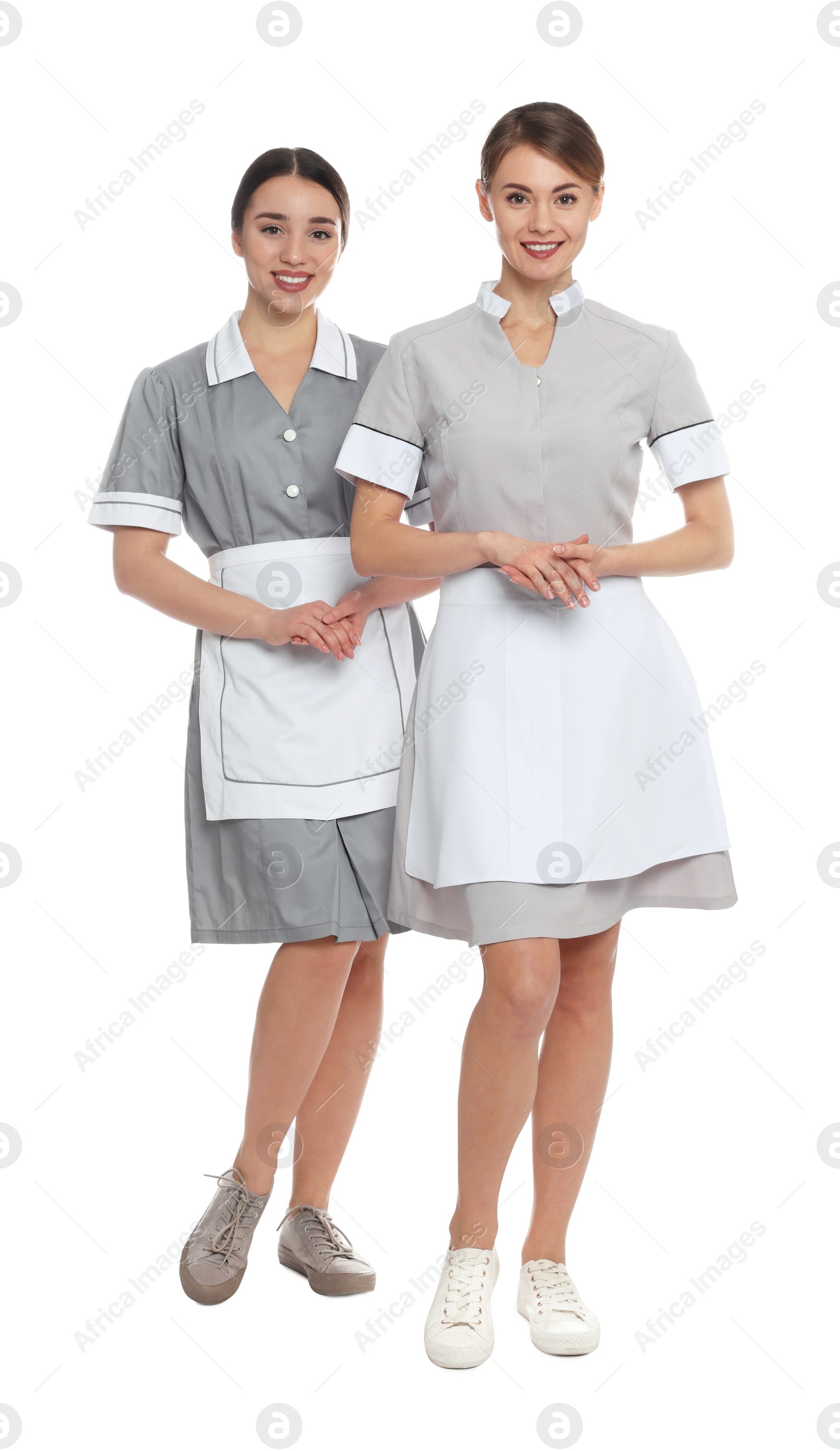 Photo of Full length portrait of chambermaids in tidy uniforms on white background