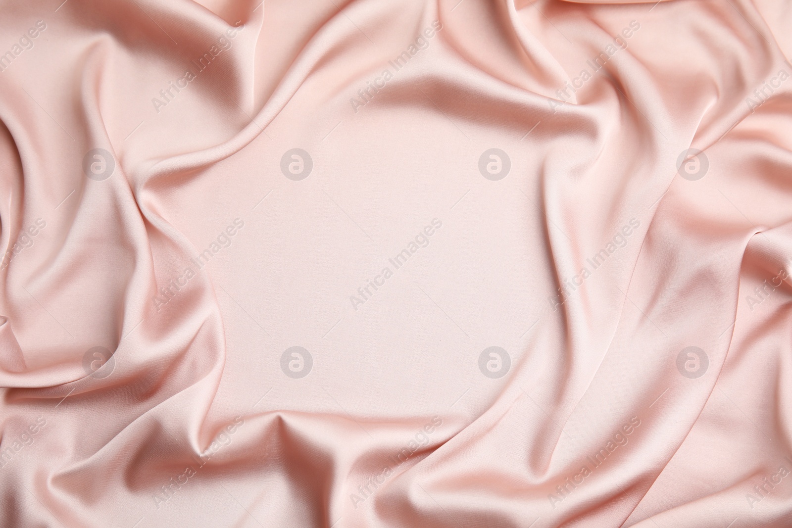 Photo of Texture of delicate pink silk as background, top view