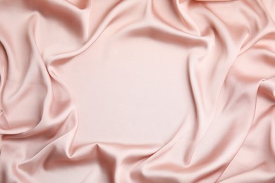 Photo of Texture of delicate pink silk as background, top view
