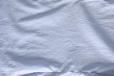 Photo of Crumpled light blue fabric as background, top view