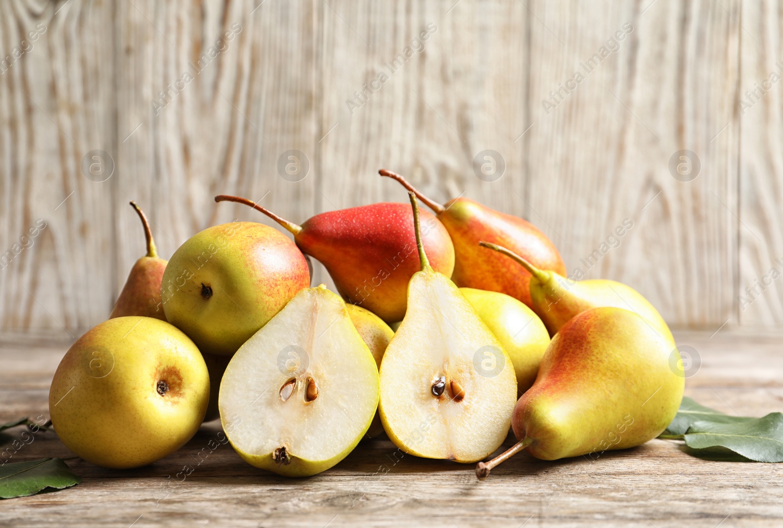 Photo of Ripe pears on wooden table. Healthy snack