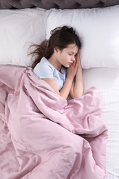 Beautiful little girl sleeping in bed, top view