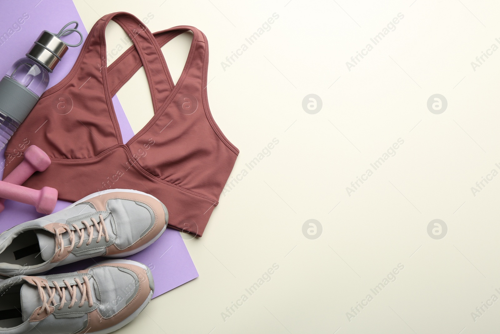 Photo of Flat lay composition with sportswear and equipment on color background, space for text. Gym workout