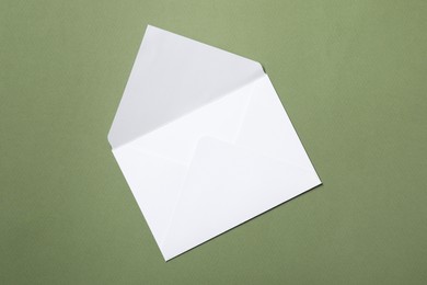 Photo of Letter envelope on green background, top view