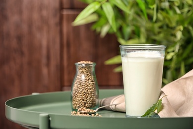 Photo of Composition with hemp milk on green table