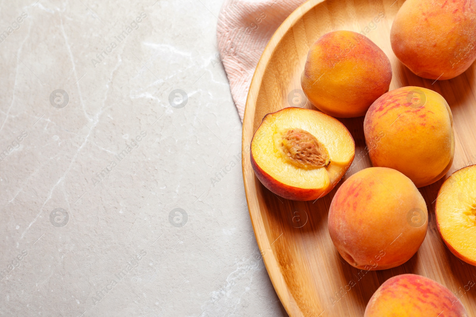 Photo of Plate with delicious ripe peaches on grey background, top view