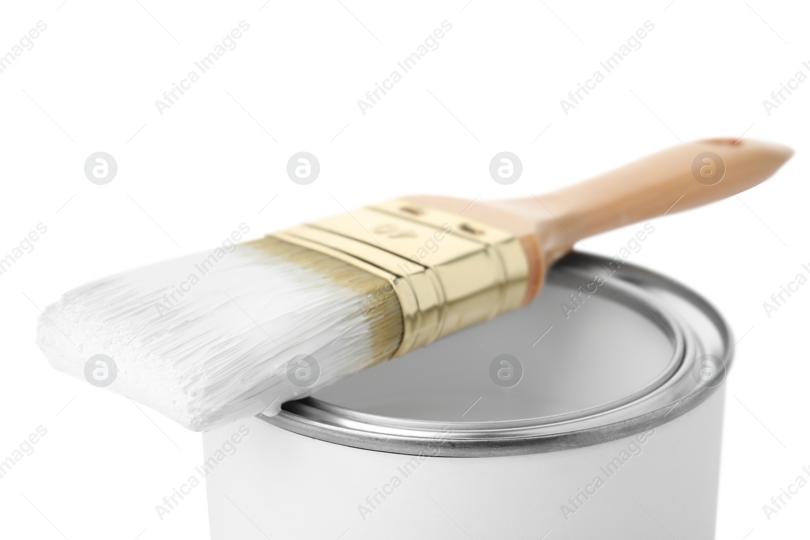 Photo of Paint can with brush on white background, closeup