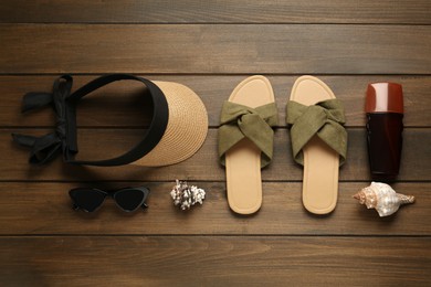 Different beach objects on wooden background, flat lay