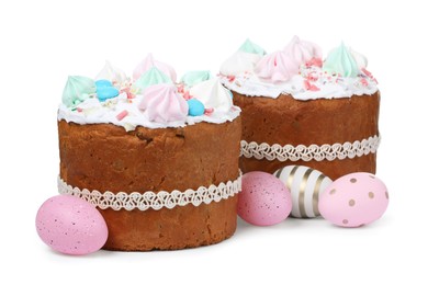 Photo of Traditional Easter cakes with meringues and painted eggs on white background
