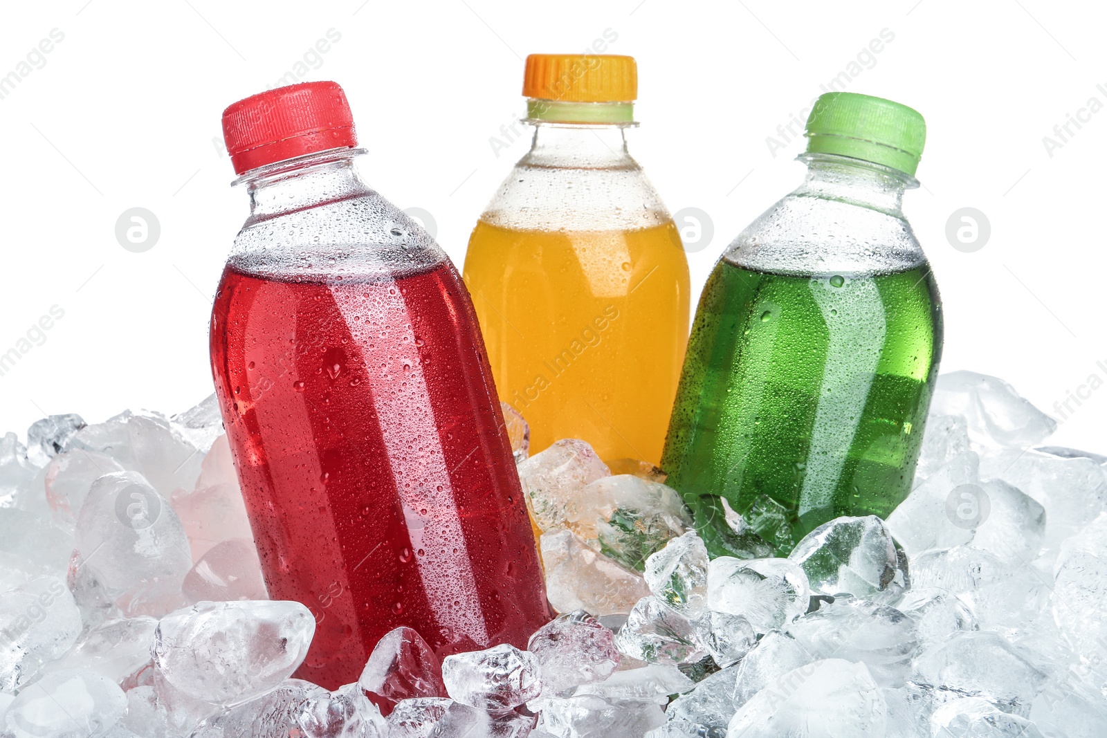 Photo of Ice cubes and different soda drinks on white background