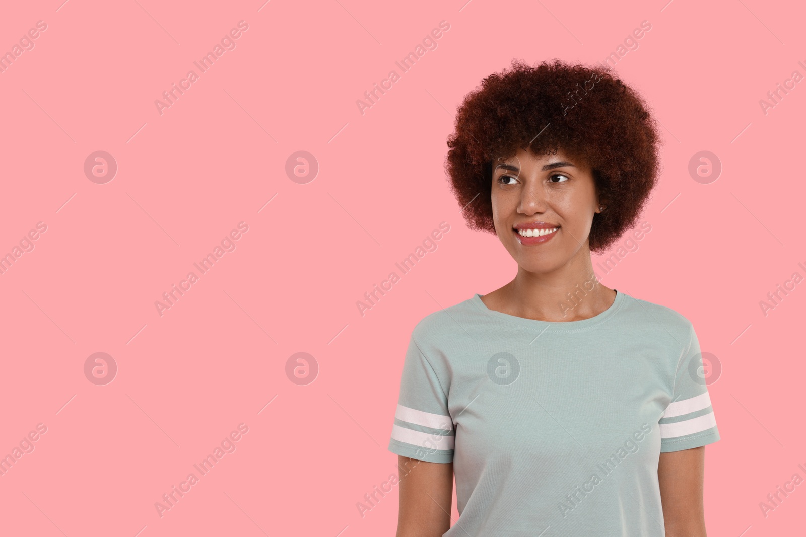 Photo of Portrait of happy young woman on pink background. Space for text