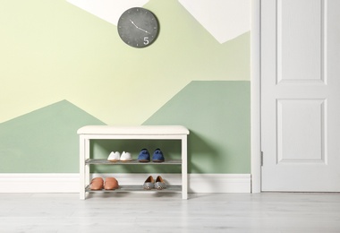 Photo of Storage bench with different female shoes indoors