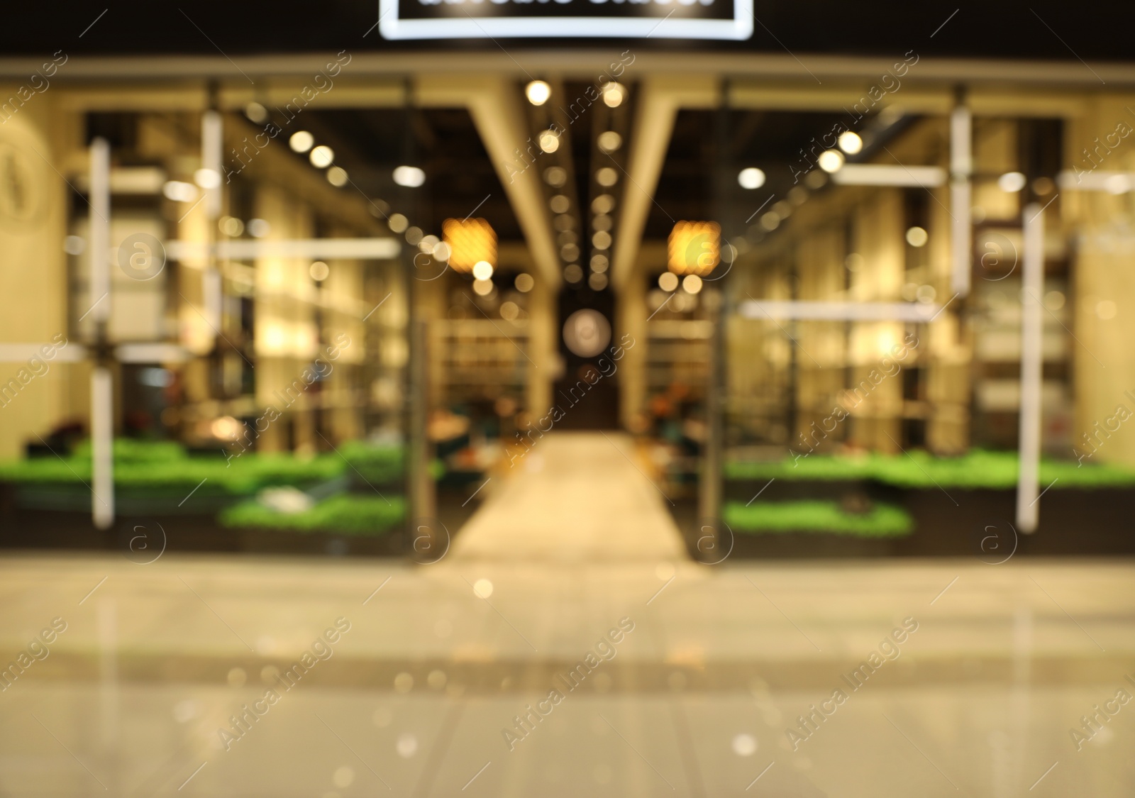 Photo of Blurred view of modern shopping mall interior. Bokeh effect