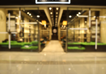 Photo of Blurred view of modern shopping mall interior. Bokeh effect