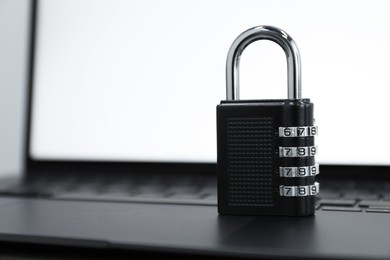 Cyber security. Metal combination padlock on laptop, closeup. Space for text