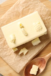 Tasty butter on parchment paper, top view