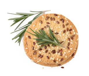Photo of Stack of round cereal crackers with flax, sunflower, sesame seeds and rosemary isolated on white, top view