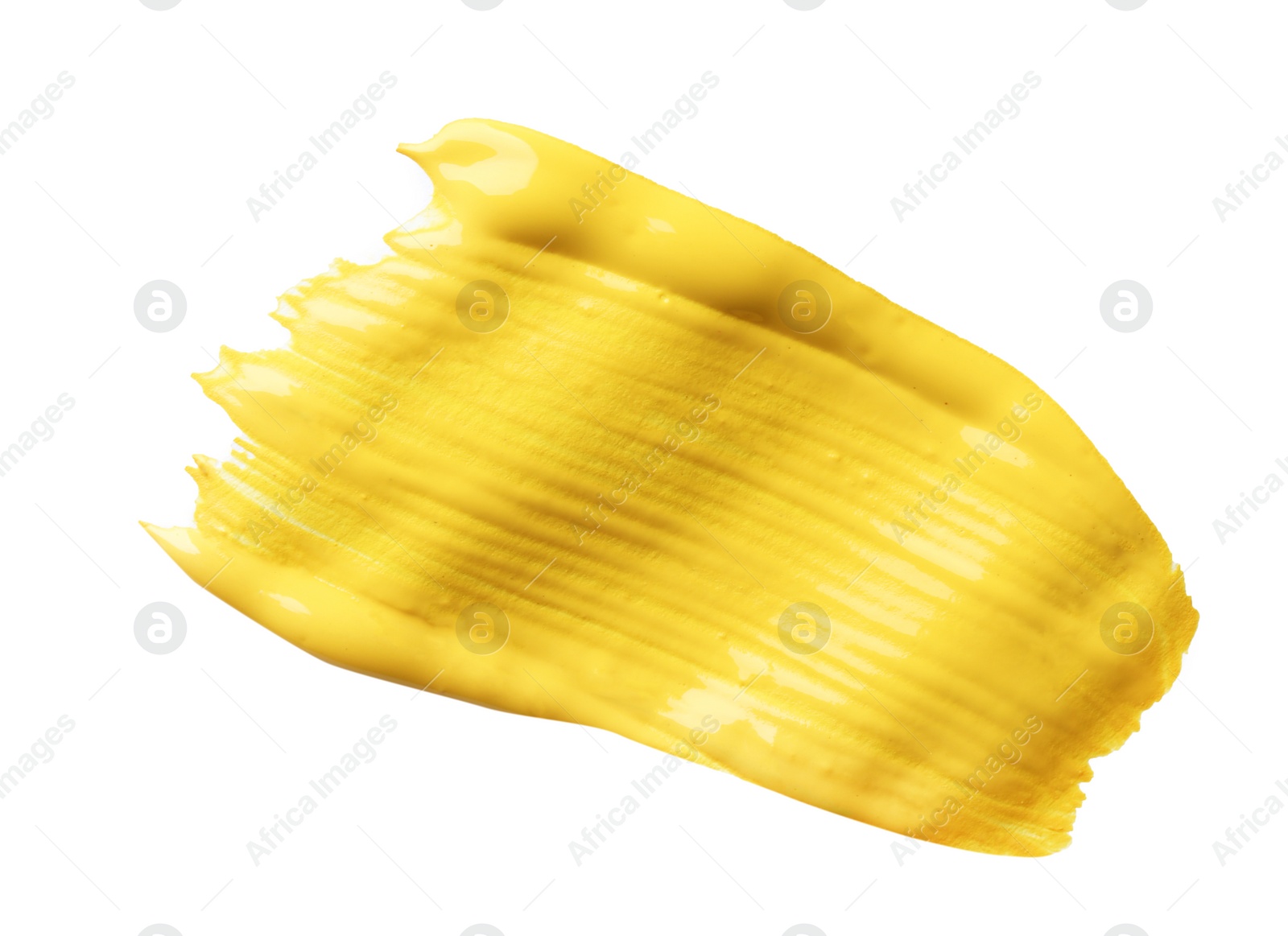 Photo of Abstract brushstroke of yellow paint isolated on white