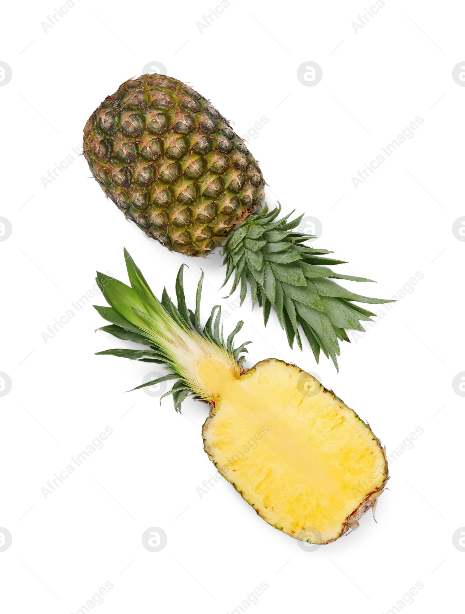 Photo of Whole and cut ripe pineapples on white background, flat lay. Space for text