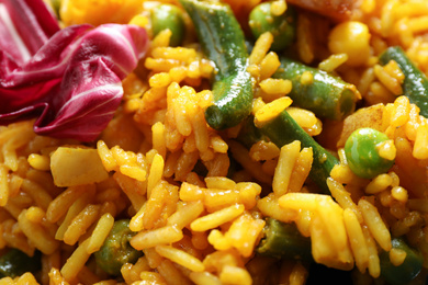 Delicious rice pilaf with vegetables as background, closeup