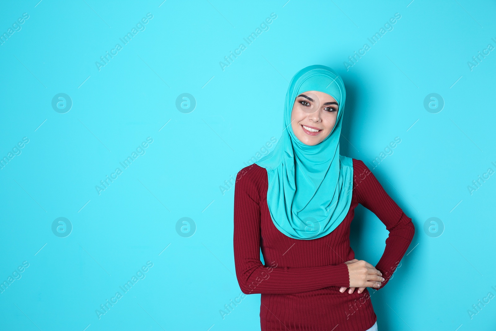 Photo of Portrait of young Muslim woman in hijab against color background. Space for text