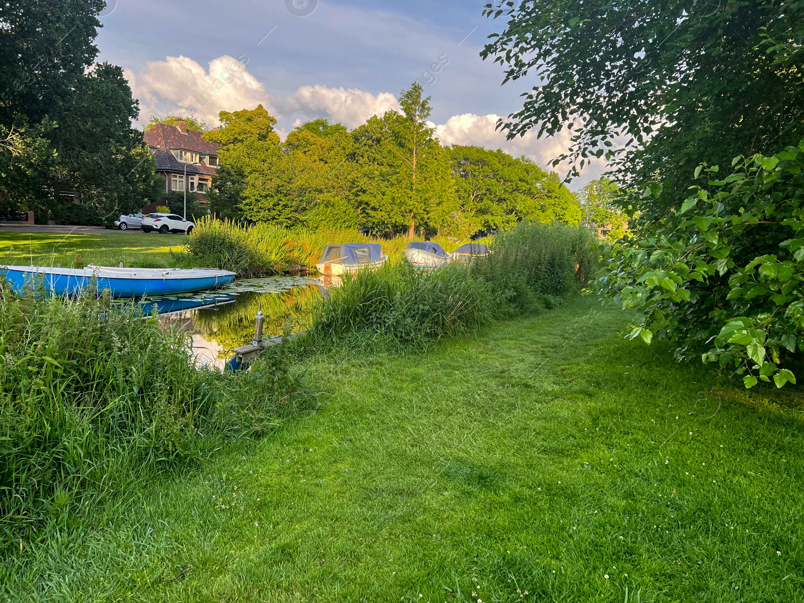 Photo of Beautiful view of moored boats in canal on sunny day