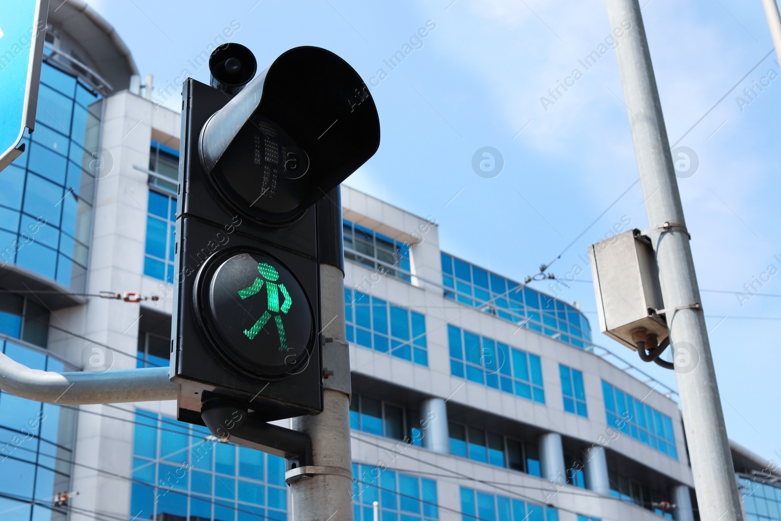 Photo of Traffic light with green signal on city street