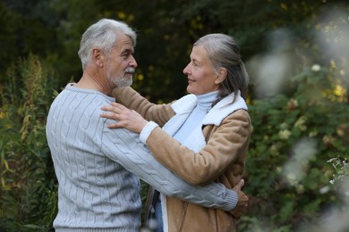 Affectionate senior couple dancing together outdoors. Romantic date