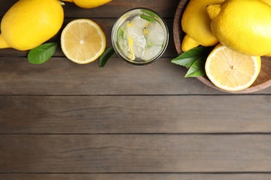 Photo of Cool freshly made lemonade and fruits on wooden table, flat lay. Space for text