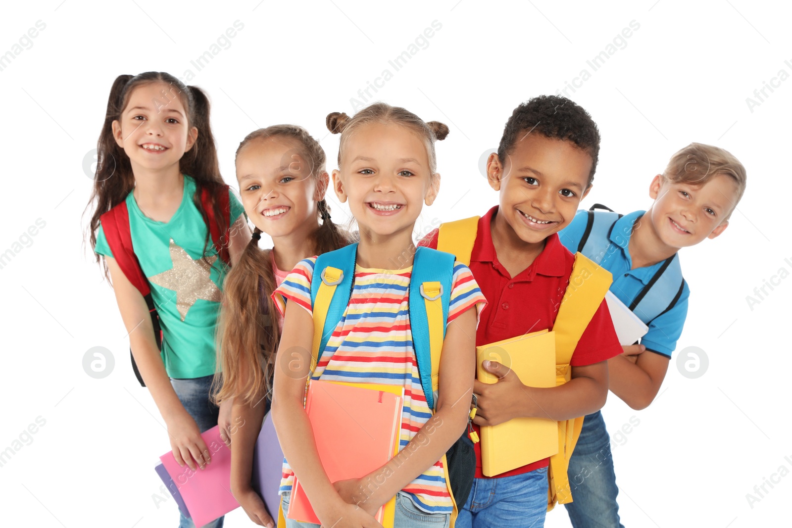 Photo of Group of little children with backpacks and school supplies on white background