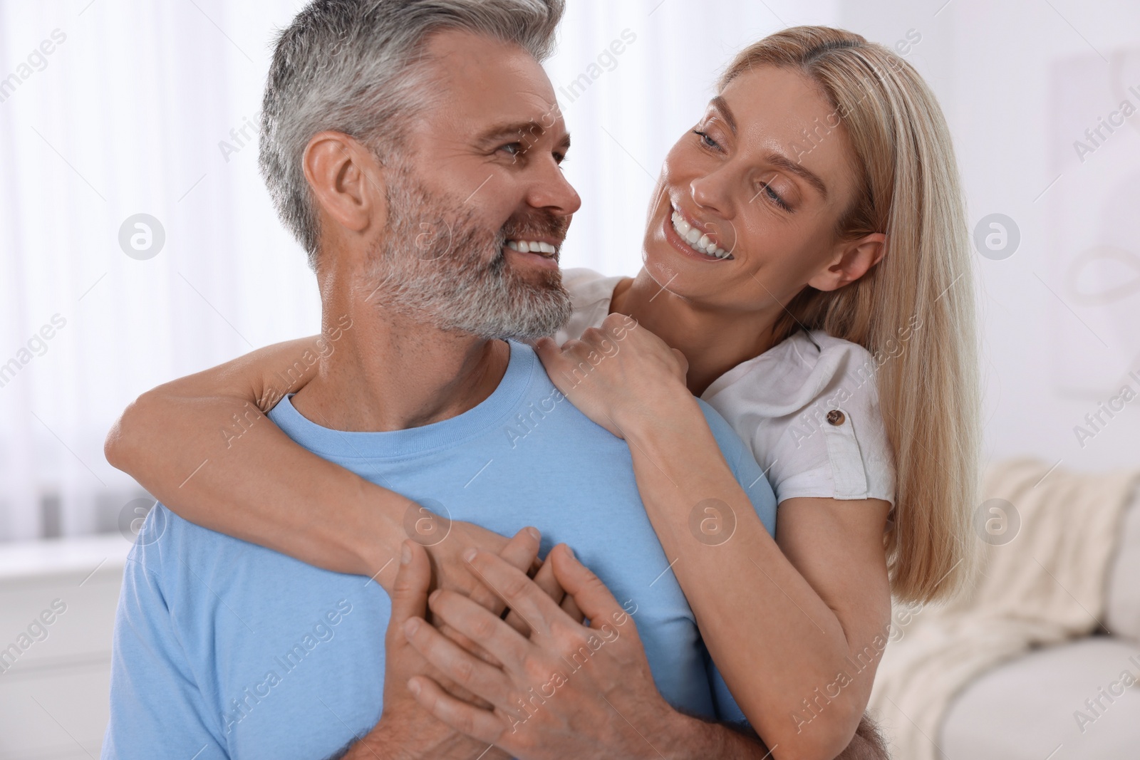 Photo of Portrait of happy affectionate couple at home. Romantic date