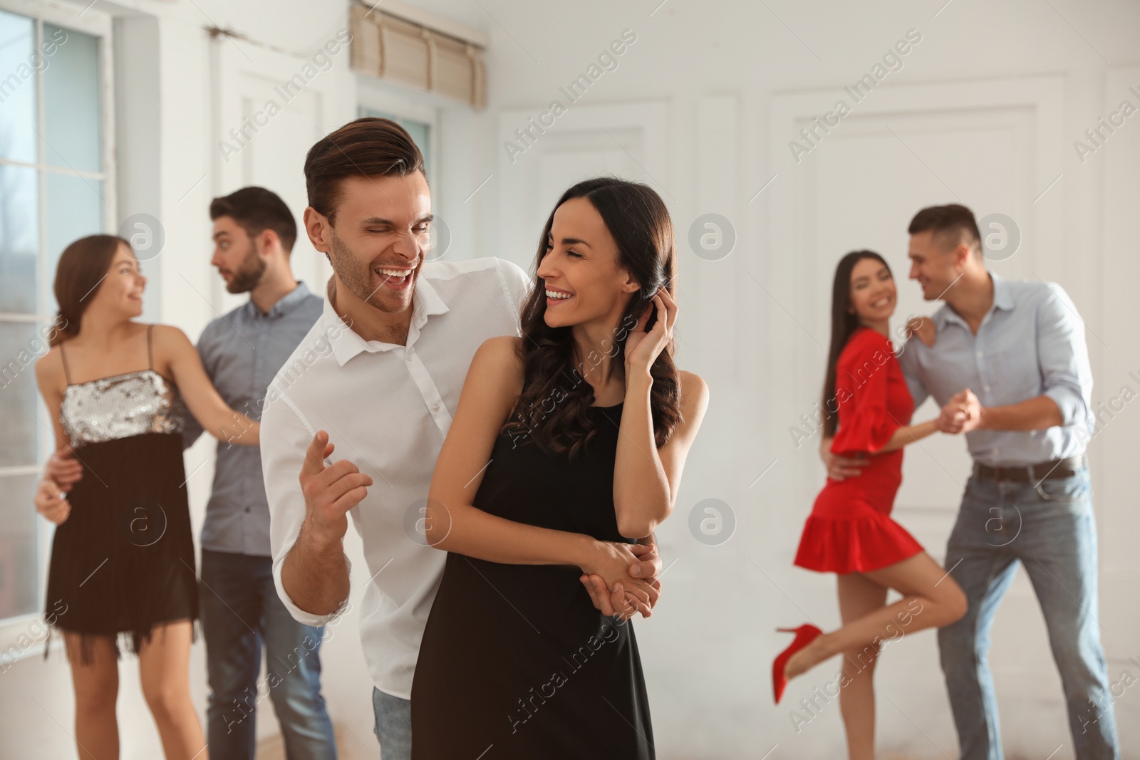 Photo of Lovely young couple dancing together at party