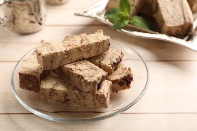 Photo of Tasty chocolate halva on wooden table, closeup