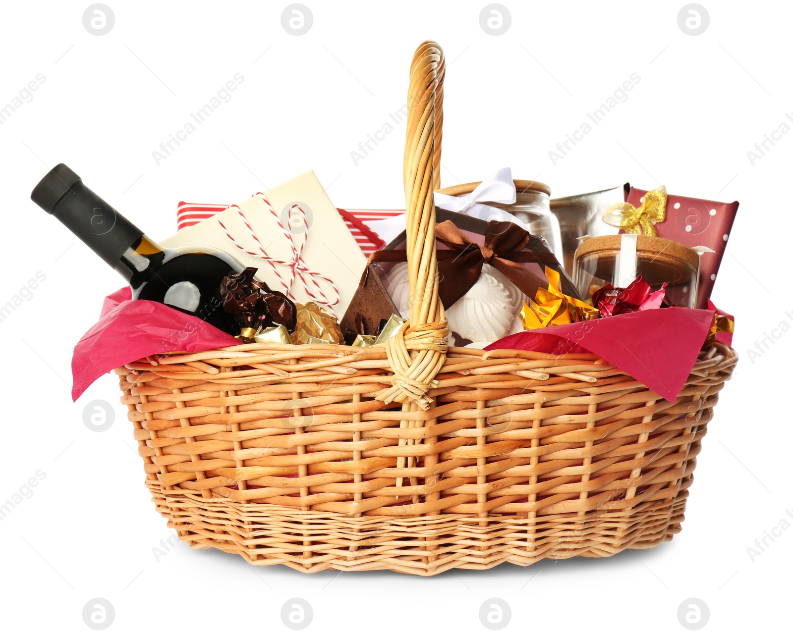 Photo of Wicker basket full of gifts isolated on white