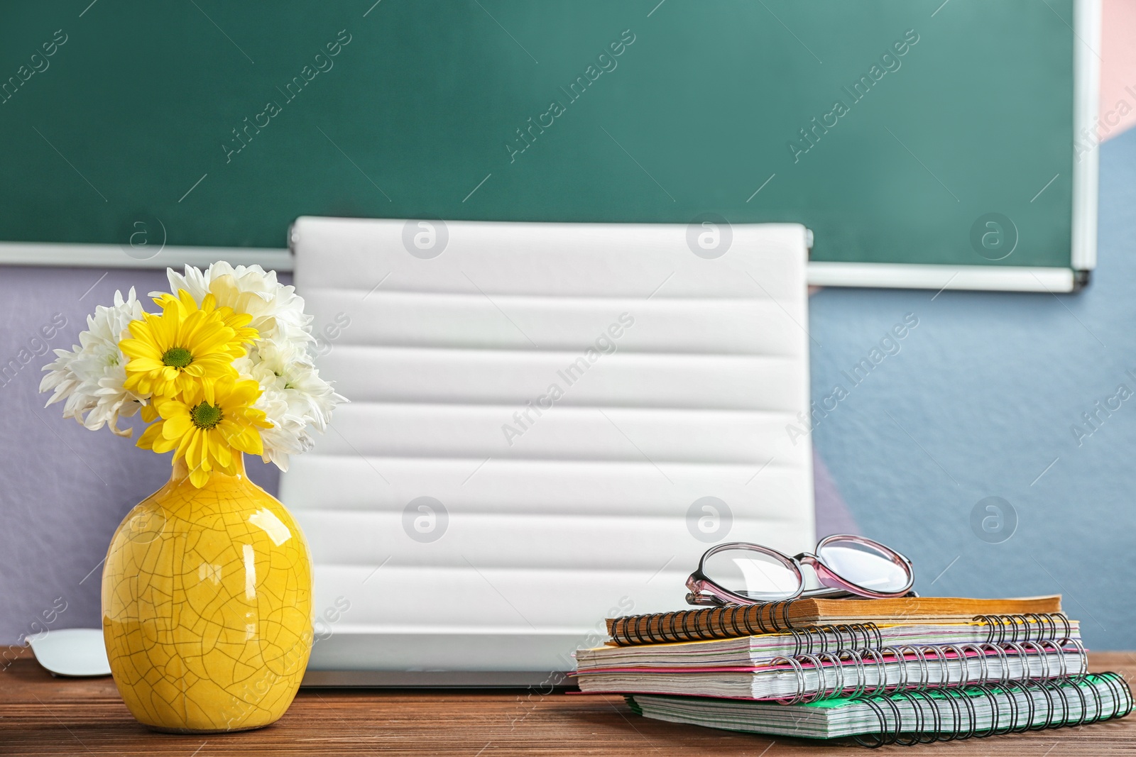 Photo of Beautiful bouquet on table in classroom. Teacher's day celebration