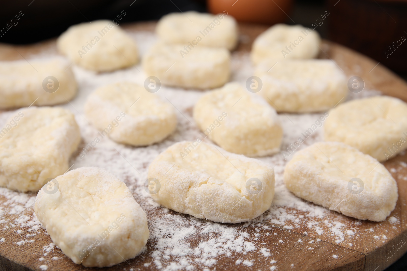 Photo of Making lazy dumplings. Cut dough and flour on wooden board, closeup