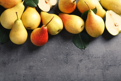 Photo of Ripe pears on grey background, top view. Space for text