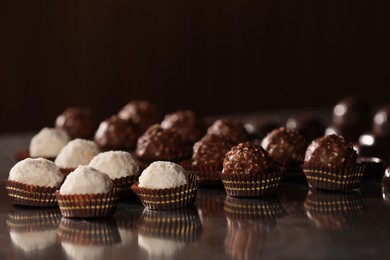 Photo of Many delicious chocolate candies on table. Production line