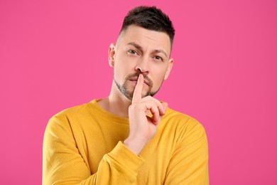 Man in casual outfit on pink background