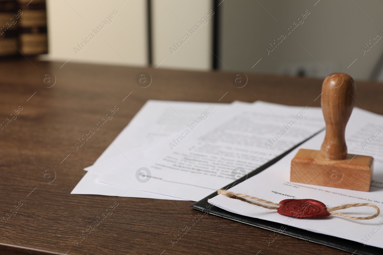 Photo of Documents and stamp on wooden table, closeup with space for text. Notary contract