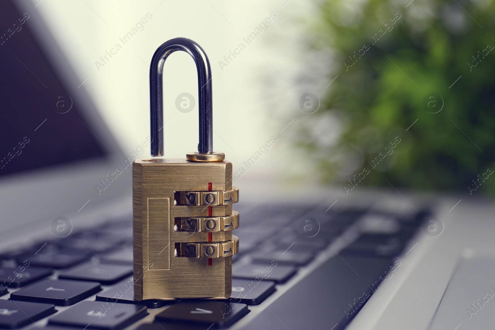 Photo of Metal code padlock on laptop keyboard, space for text. Cyber security concept