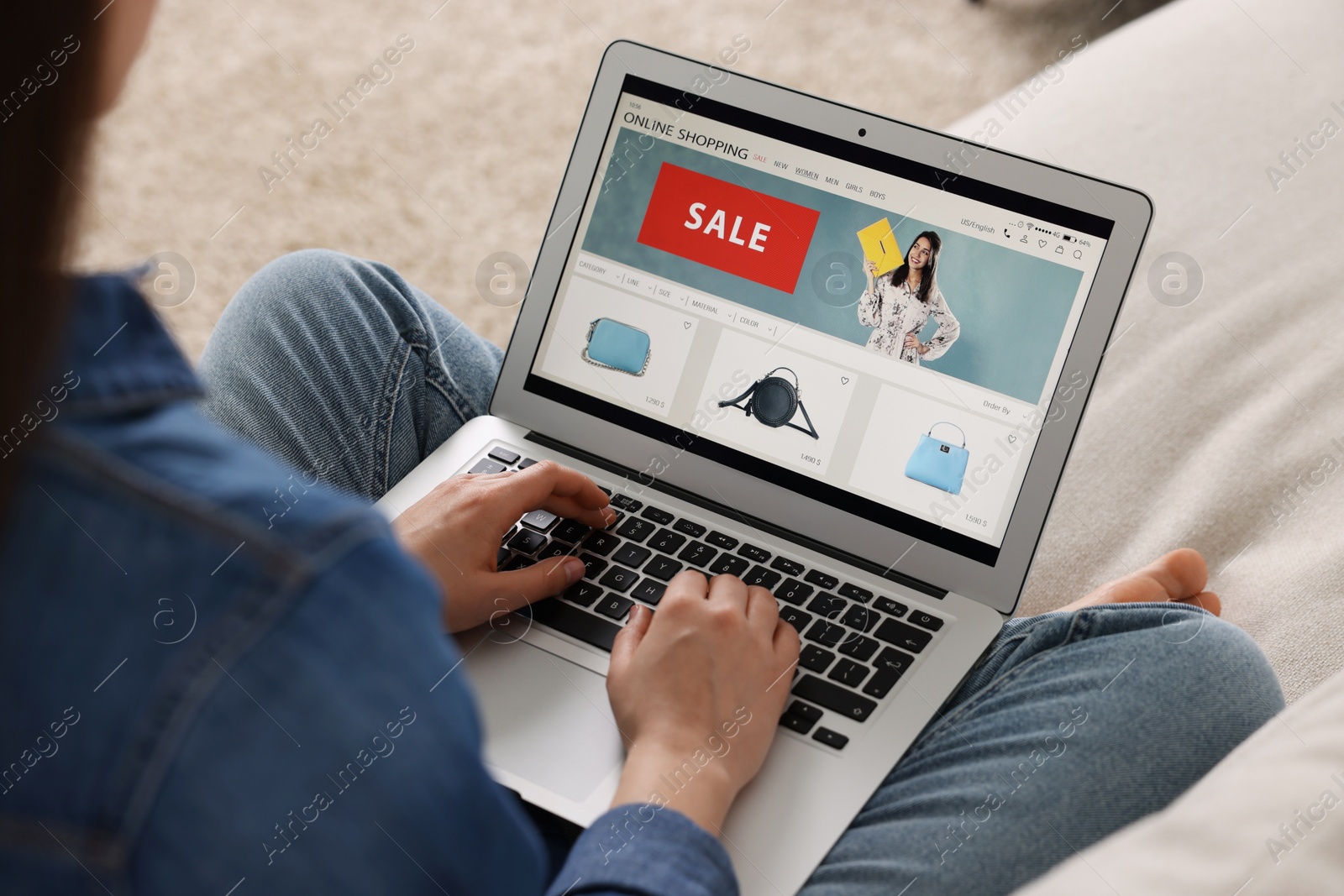 Photo of Woman shopping online during sale on laptop at home, closeup