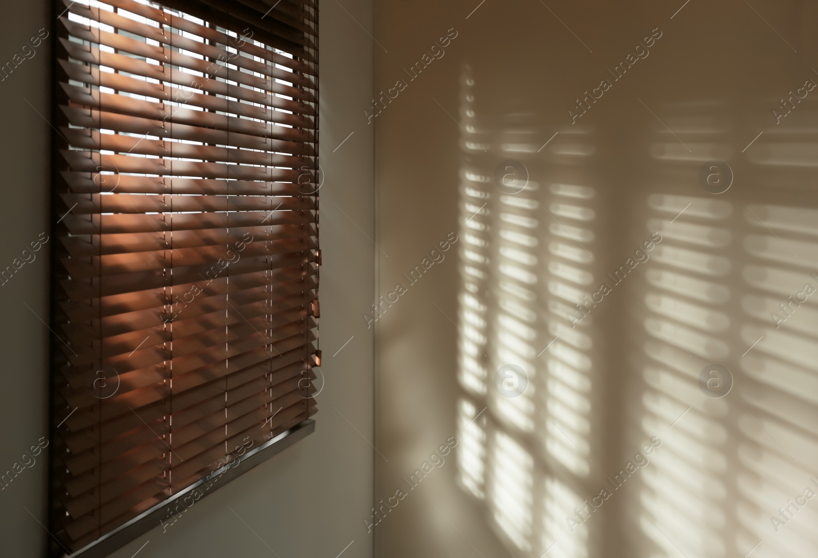 Photo of Window with horizontal blinds in room. Space for text