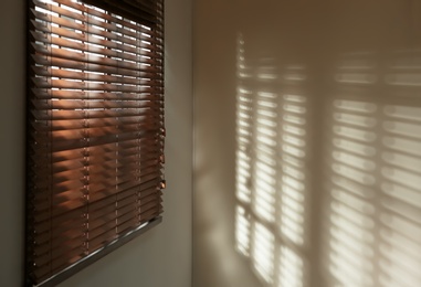 Window with horizontal blinds in room. Space for text