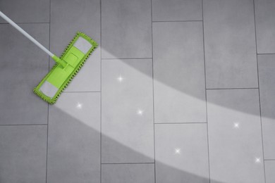 Washing floor with mop indoors, top view. Clean and shiny trace on dirty surface