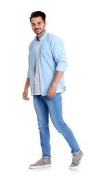 Young man in stylish jeans on white background