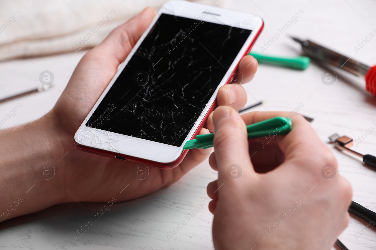Photo of Technician fixing mobile phone at table, closeup. Device repair service