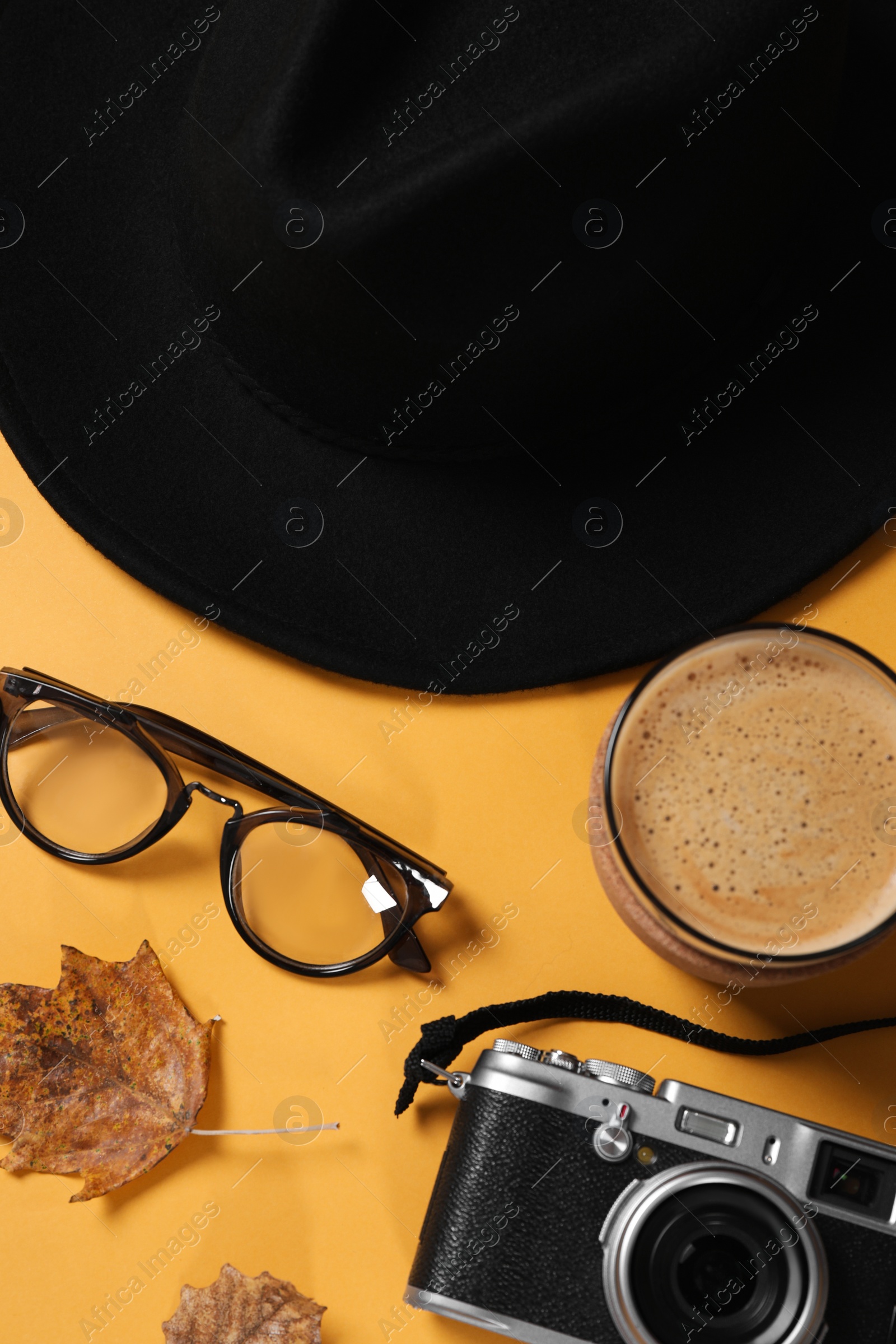 Photo of Flat lay composition with stylish hat on yellow background