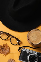 Flat lay composition with stylish hat on yellow background